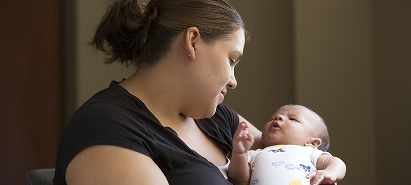 A patient holds her baby