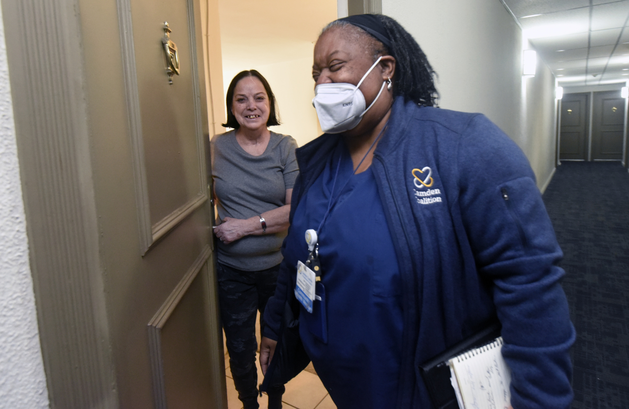 Camden Coalition care team member leaving a participant's apartment after a home visit